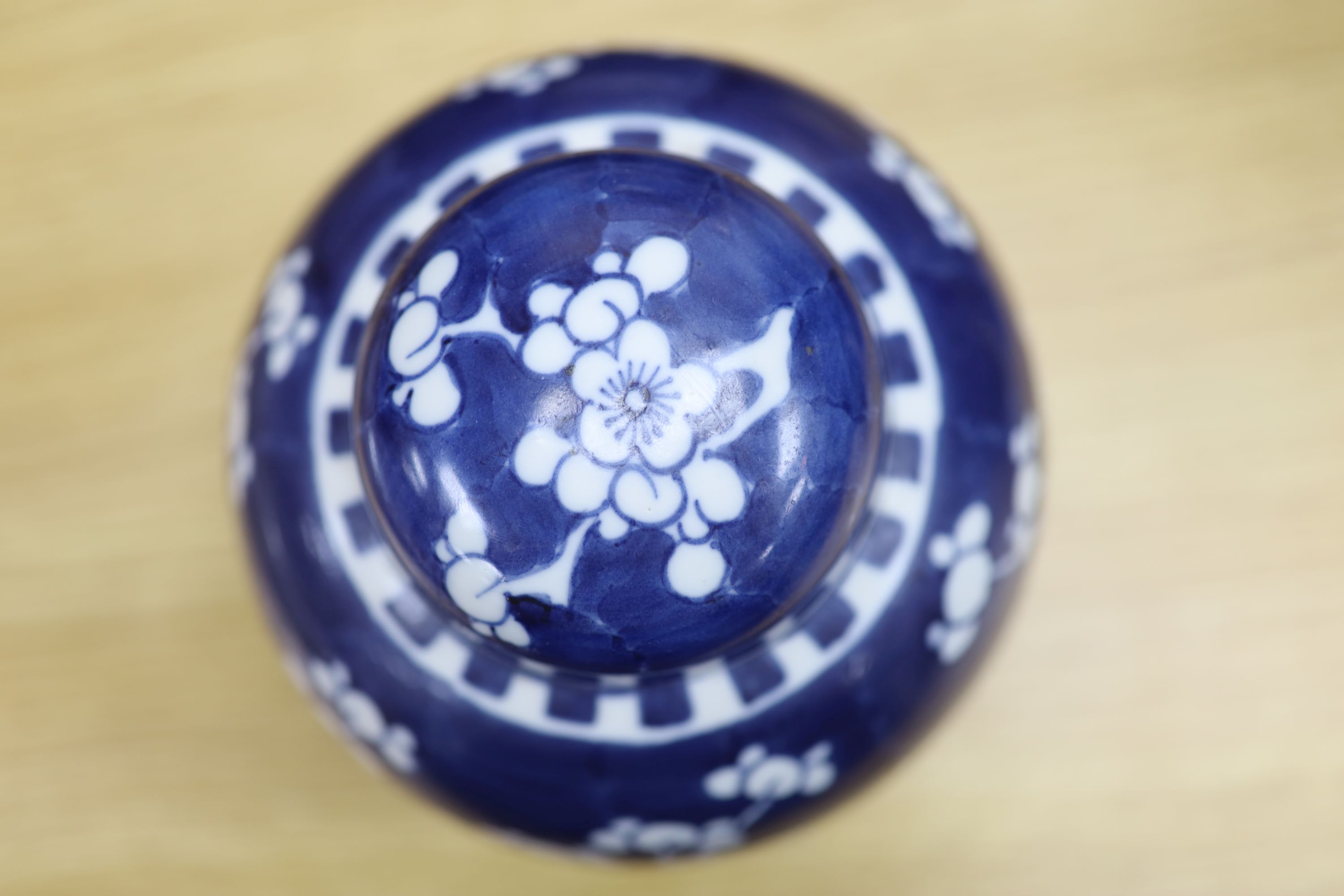 Two Chinese blue and white prunus pattern ginger jars and a similar cylinder vase, tallest 26cm